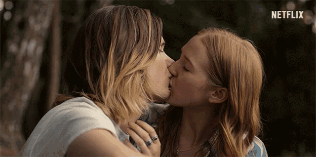 two women kissing with a netflix logo behind them