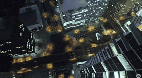 an aerial view of a city at night with the ea logo on the bottom right