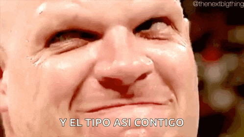 a close up of a man 's face with the words y el tipo asi contigo written below him .