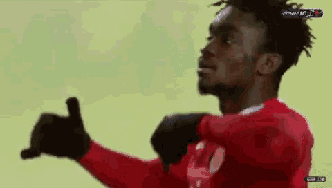 a man in a red shirt is being lifted by another man in a red shirt