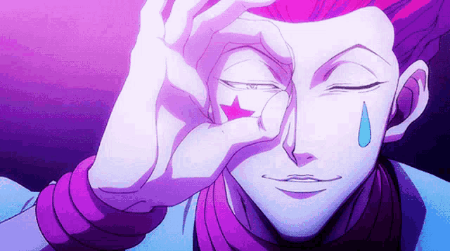 a close up of a person 's face with a tear coming out of his eye and a star on his forehead .