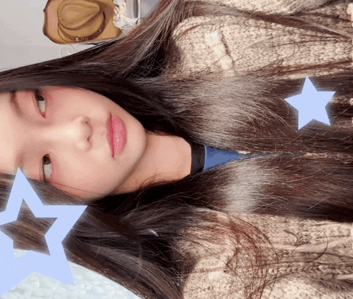 a girl with long hair and a hat behind her