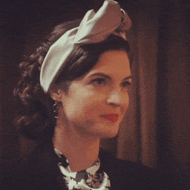 a woman wearing a white headband and a black jacket