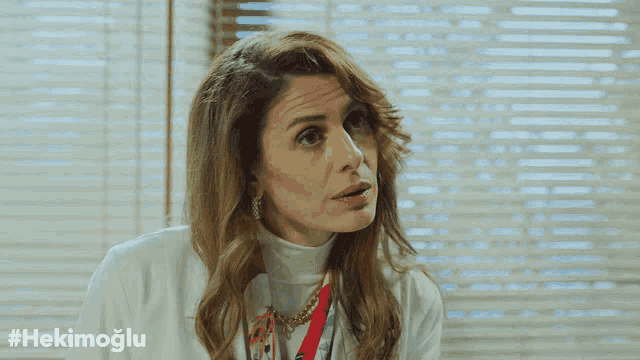 a woman in a white coat with the hashtag #hekimoglu on the bottom right