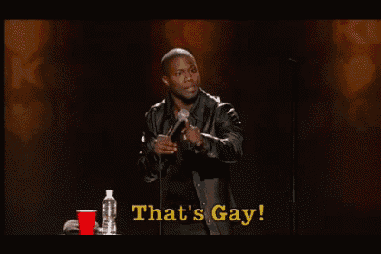 a man speaking into a microphone with the words that 's gay on the bottom