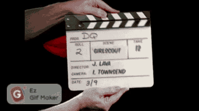 a person is holding a clapper board that says ' dq ' on it