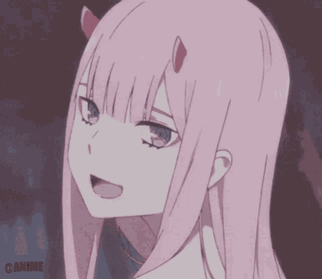 a close up of a girl with pink hair and blue eyes .
