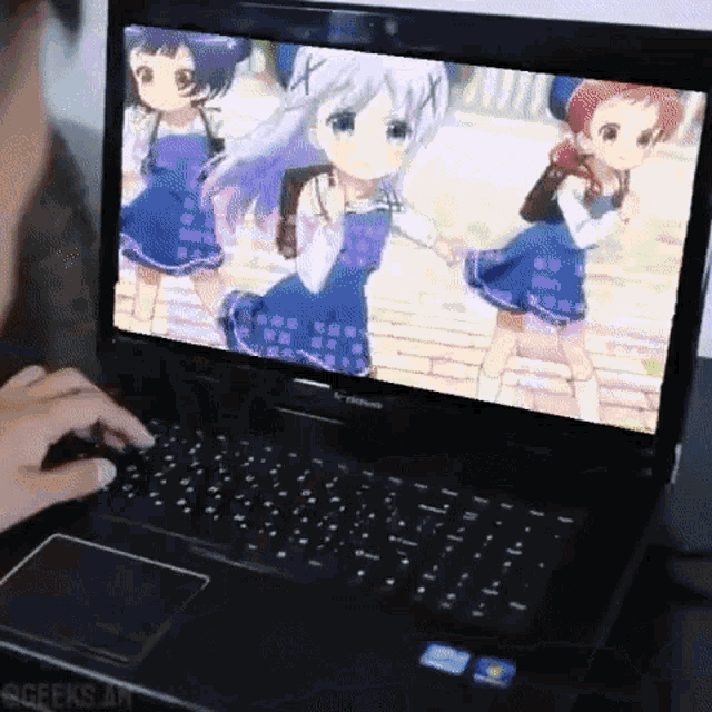 a person is using a laptop with a picture of three girls on the screen