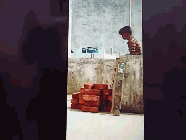 a stack of red bricks is hanging from a wall