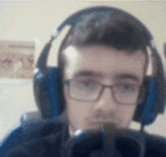 a man wearing headphones and glasses is taking a selfie
