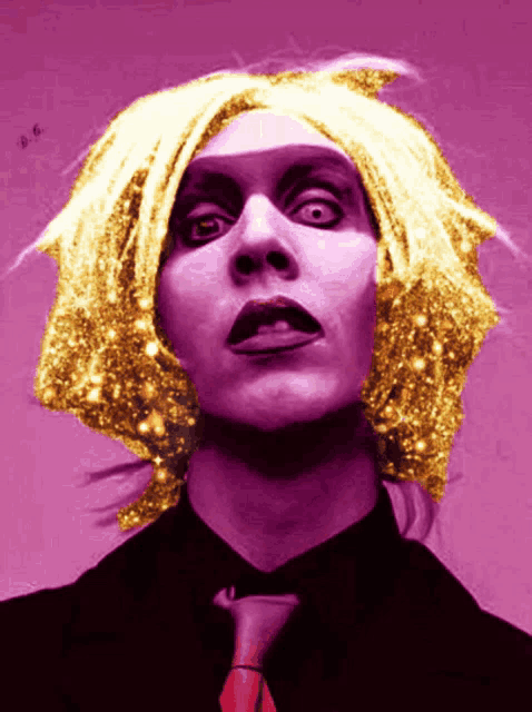 a woman with a purple shirt and a red tie is wearing a gold wig