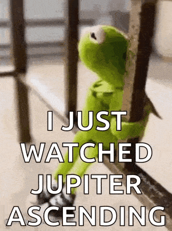 kermit the frog is sitting on a railing holding onto a railing and watching jupiter ascending .