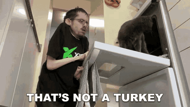 a man standing next to an oven with the words that 's not a turkey on the bottom