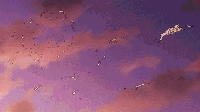 a purple sky with a few pieces of paper flying through it