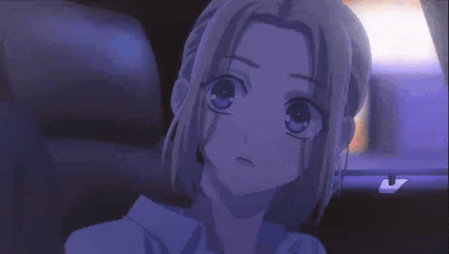 a girl with long blonde hair is sitting in a dark room