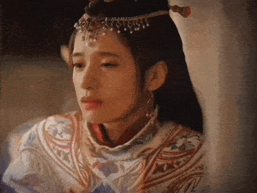 a woman with a crown on her head has tears coming out of her eyes