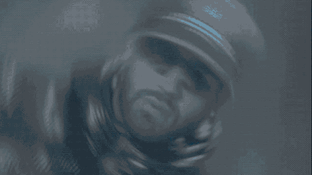 a blurry picture of a man in a black jacket and hat