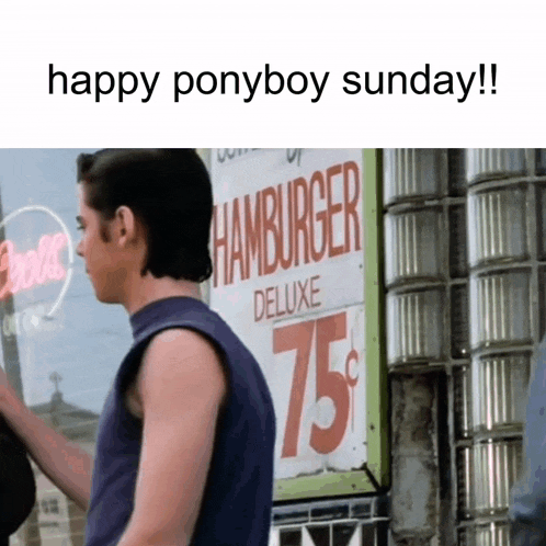 a man is standing in front of a hamburger deluxe sign for 75 cents