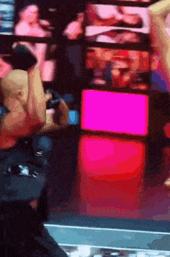 a blurry picture of a person standing in front of a pink light