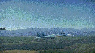a fighter jet is flying over a field with a mountain in the background