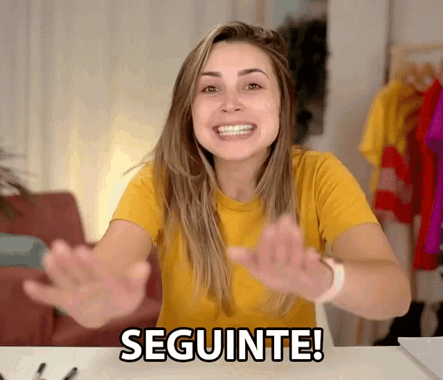 a woman in a yellow shirt says seguinte with her hands out