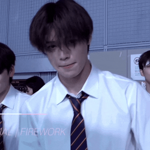 a man in a white shirt and tie with the word firework behind him