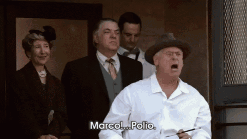 a man in a white shirt is screaming and says marco polio