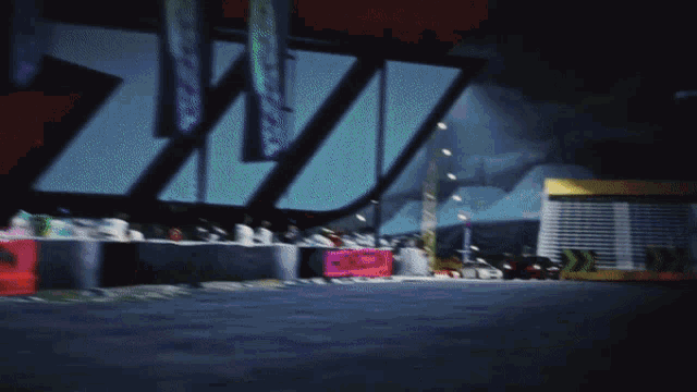 a blurry picture of a race track with a sign that says ' w '