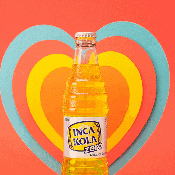 a bottle of inca kola zero sits in front of a heart shaped background