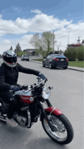 a person is riding a motorcycle down a street