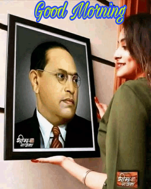 a woman is holding a framed picture of a man with glasses and the words good morning on the bottom