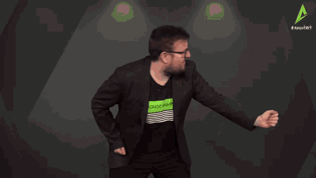 a man wearing a black jacket and a green shirt that says " axion gaming "