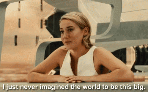 a woman sits at a table with the words " i just never imagined the world to be this big " below her