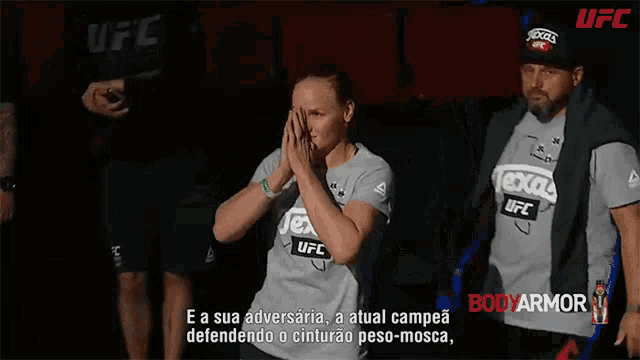 a person wearing a texas ufc shirt is being led by a man