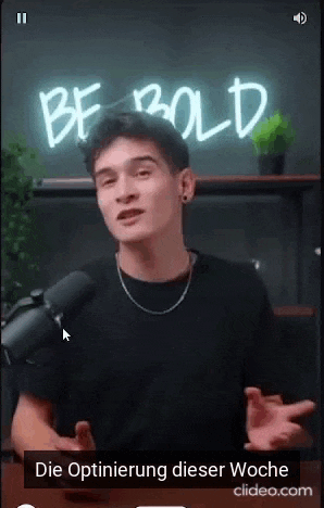 a man is talking into a microphone in front of a sign that says be bold .