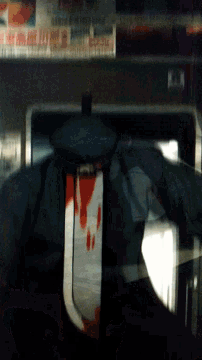 a blurry picture of a person holding a bloody knife in front of a newspaper that says ' chicago '