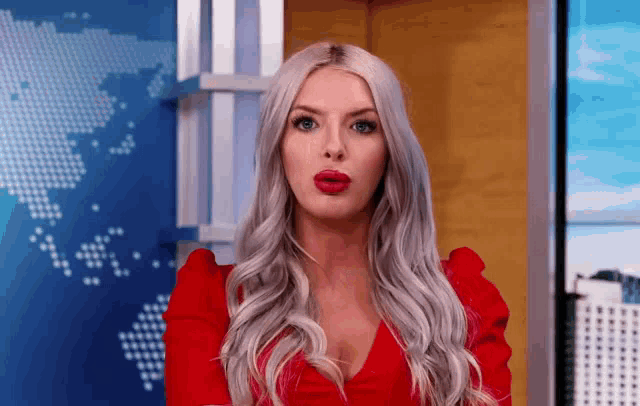 a woman in a red dress is making a face