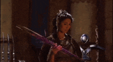a woman in a purple dress is standing in a room with purple smoke coming out of her dress .