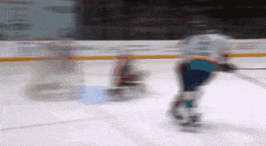 a blurred image of a hockey game with a player wearing a jersey that says ' a ' on it