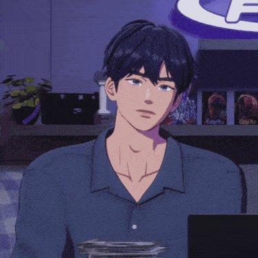 a man in a blue shirt is clapping his hands in front of a sign that says e