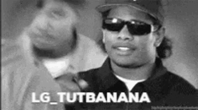 a black and white photo of a man wearing sunglasses and a hat that says lg_tutbanana