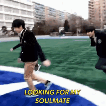 two men are running on a field with the words " looking for my soulmate " written above them