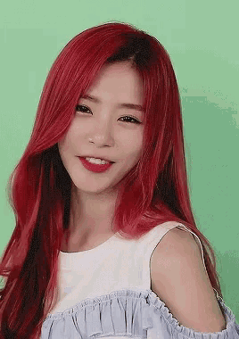 a woman with red hair wearing a white top