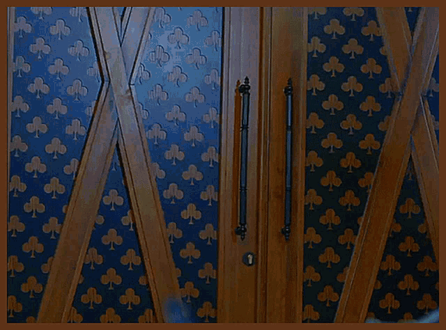 a door with a pattern of clubs on the wall behind it