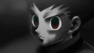 a close up of a person 's face with red eyes and a black background .