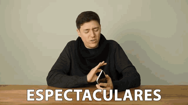 a man sitting at a table with the word espectaculares written on it