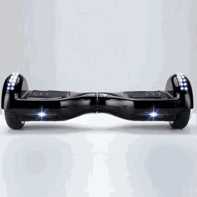 a black hover board with blue lights on the front