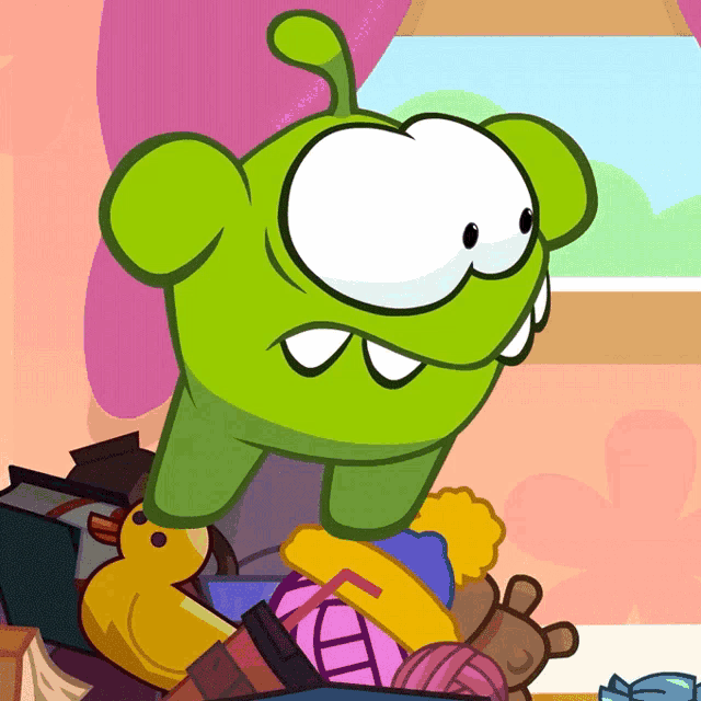 a cartoon of a green monster sitting in a pile of toys