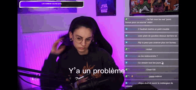 a woman sitting in front of a microphone with the words y 'a un probleme on the bottom