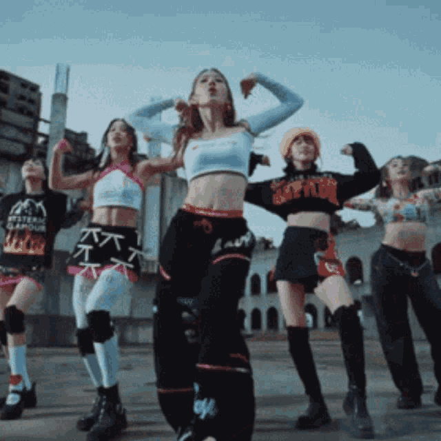 a group of women are dancing and one of them has a shirt that says i am a total gamour on it